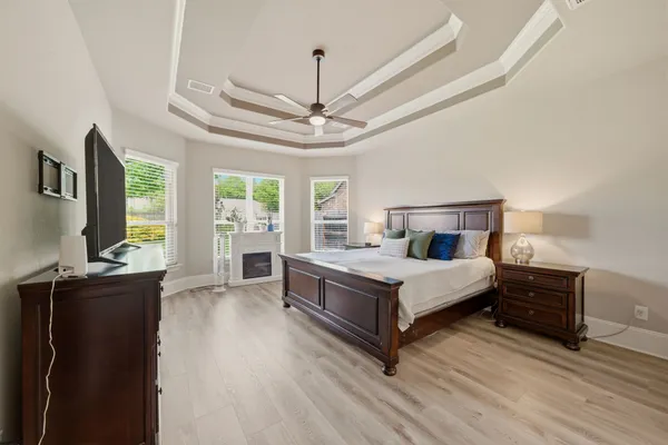 a bedroom with a bed and a flat tv screen on a dresser