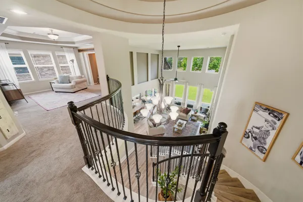 a living room with furniture large window and flat screen tv