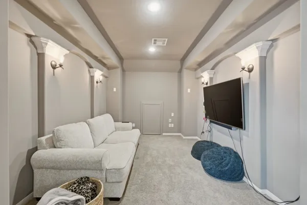 a bedroom with a bed next to a window