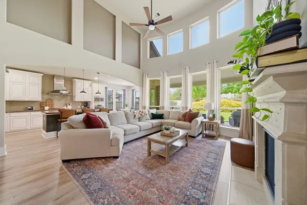 a living room with fireplace furniture and a potted plant