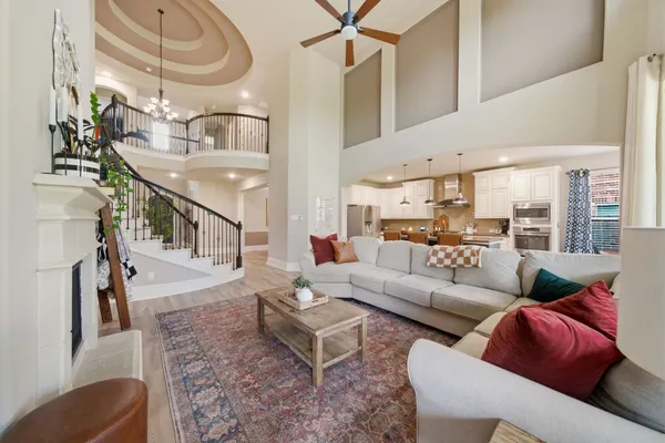 a living room with furniture and a chandelier
