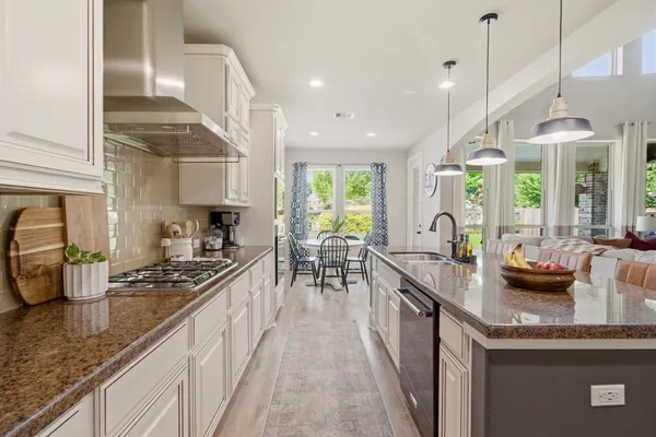 a kitchen with sink stove and cabinets