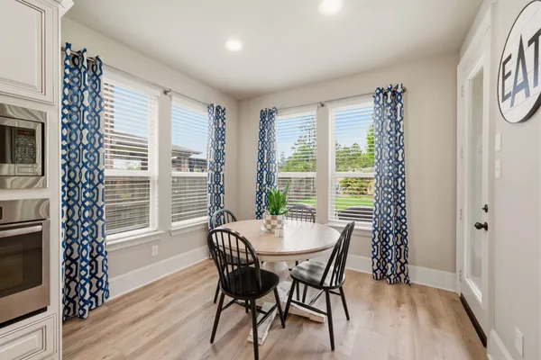 a view of a dining room with furniture window and wooden floor
