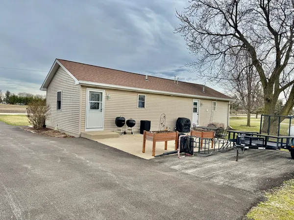 a view of a chairs and tables in the back yard of the house