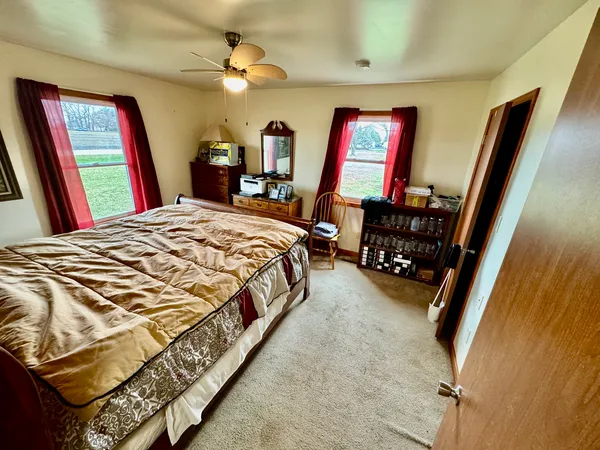 a bed sitting in a bedroom next to a window