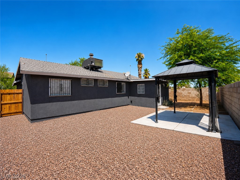 2870 South Sandhill Road Las Vegas, NV 89121 - Photo 16 of 64 A spacious backyard features a gazebo over a concrete patio, ideal for outdoor gatherings.