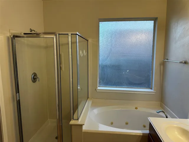 a bathroom with a bathtub and a shower