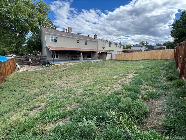 a view of a house with a backyard and a garden