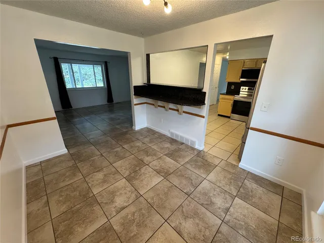 a view of a hallway with wooden floor and windows