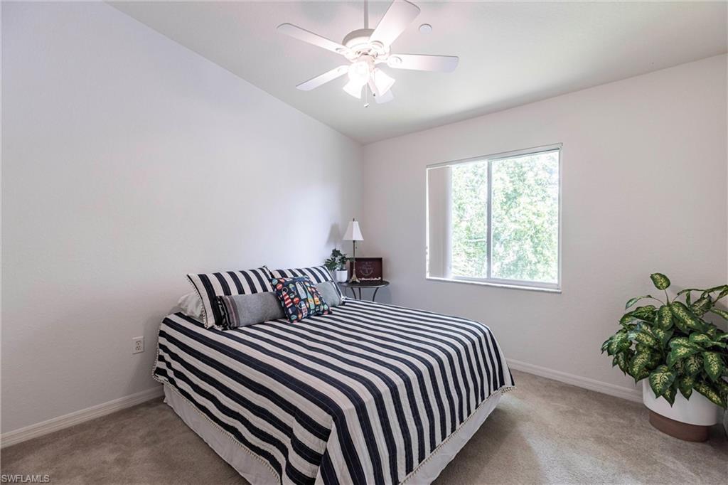 8274 Key Royal Circle, Unit 1036 Naples, FL 34119 - Photo 17 of 45 Carpeted bedroom featuring baseboards and a ceiling fan