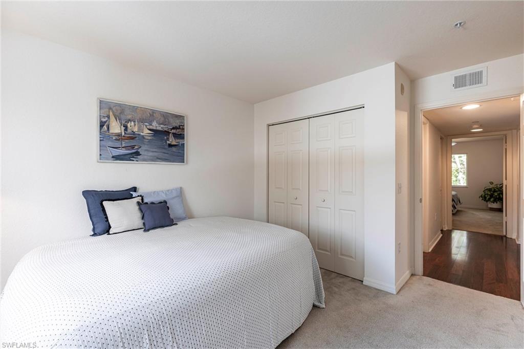 8274 Key Royal Circle, Unit 1036 Naples, FL 34119 - Photo 22 of 45 Carpeted bedroom with a closet and baseboards