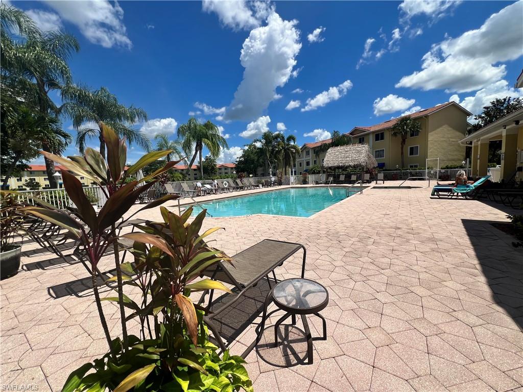 8274 Key Royal Circle, Unit 1036 Naples, FL 34119 - Photo 27 of 45 Community pool featuring a patio