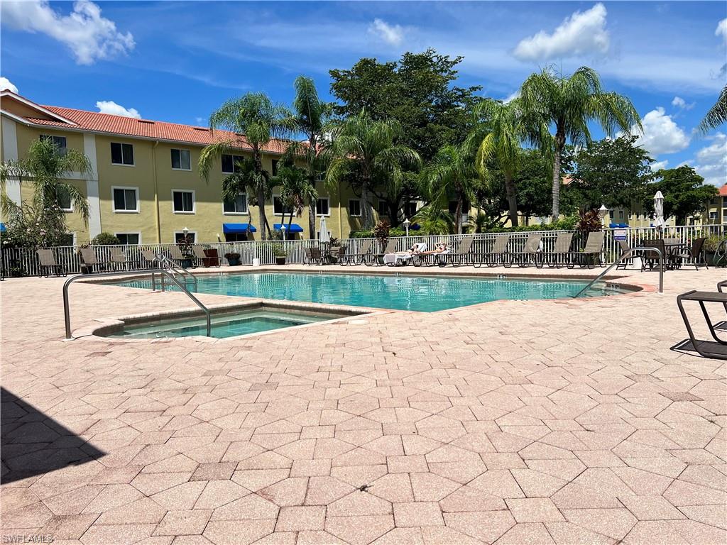 8274 Key Royal Circle, Unit 1036 Naples, FL 34119 - Photo 28 of 45 Community pool featuring a community hot tub and a patio