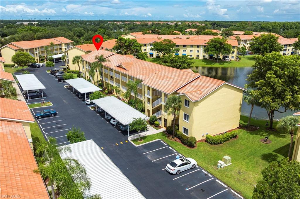 8274 Key Royal Circle, Unit 1036 Naples, FL 34119 - Photo 41 of 45 Aerial view of a nearby body of water and apartment complex / building