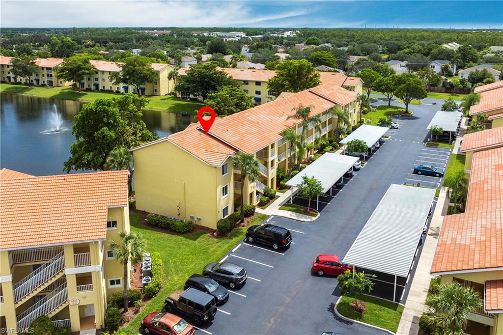 8274 Key Royal Circle, Unit 1036 Naples, FL 34119 - Photo 42 of 45 Aerial view of apartment complex and a nearby body of water
