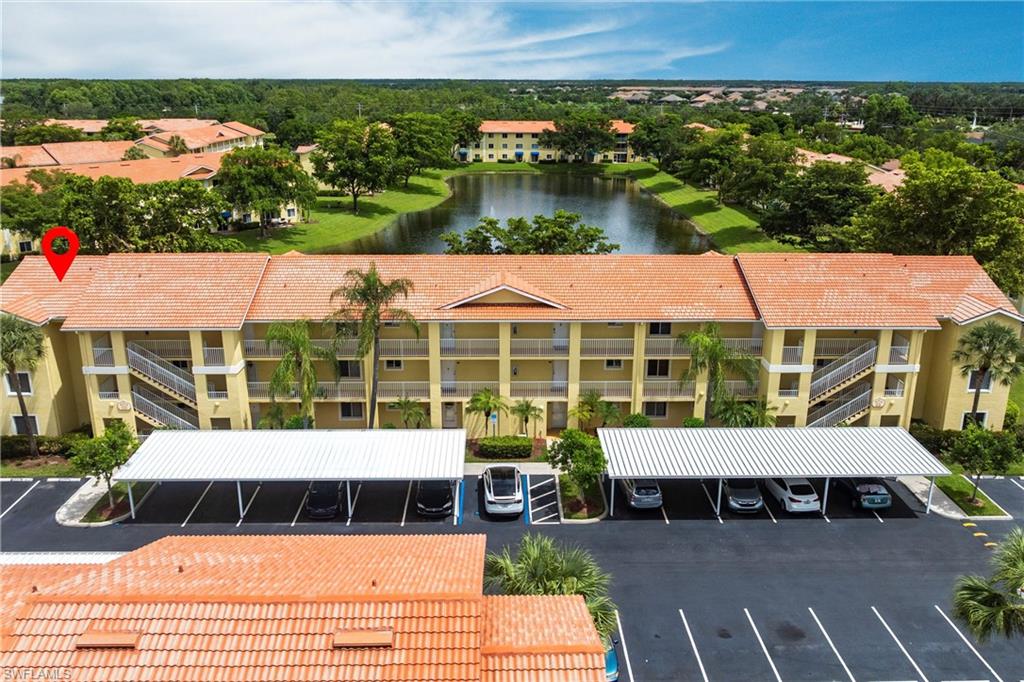 8274 Key Royal Circle, Unit 1036 Naples, FL 34119 - Photo 43 of 45 Drone / aerial view of a nearby body of water and apartment complex / building