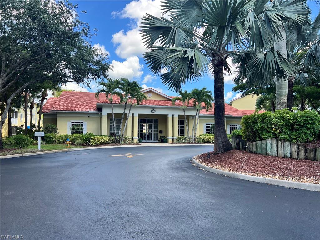 8274 Key Royal Circle, Unit 1036 Naples, FL 34119 - Photo 44 of 45 View of building exterior featuring driveway