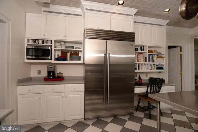 a bathroom with a granite countertop sink toilet a large mirror and a window