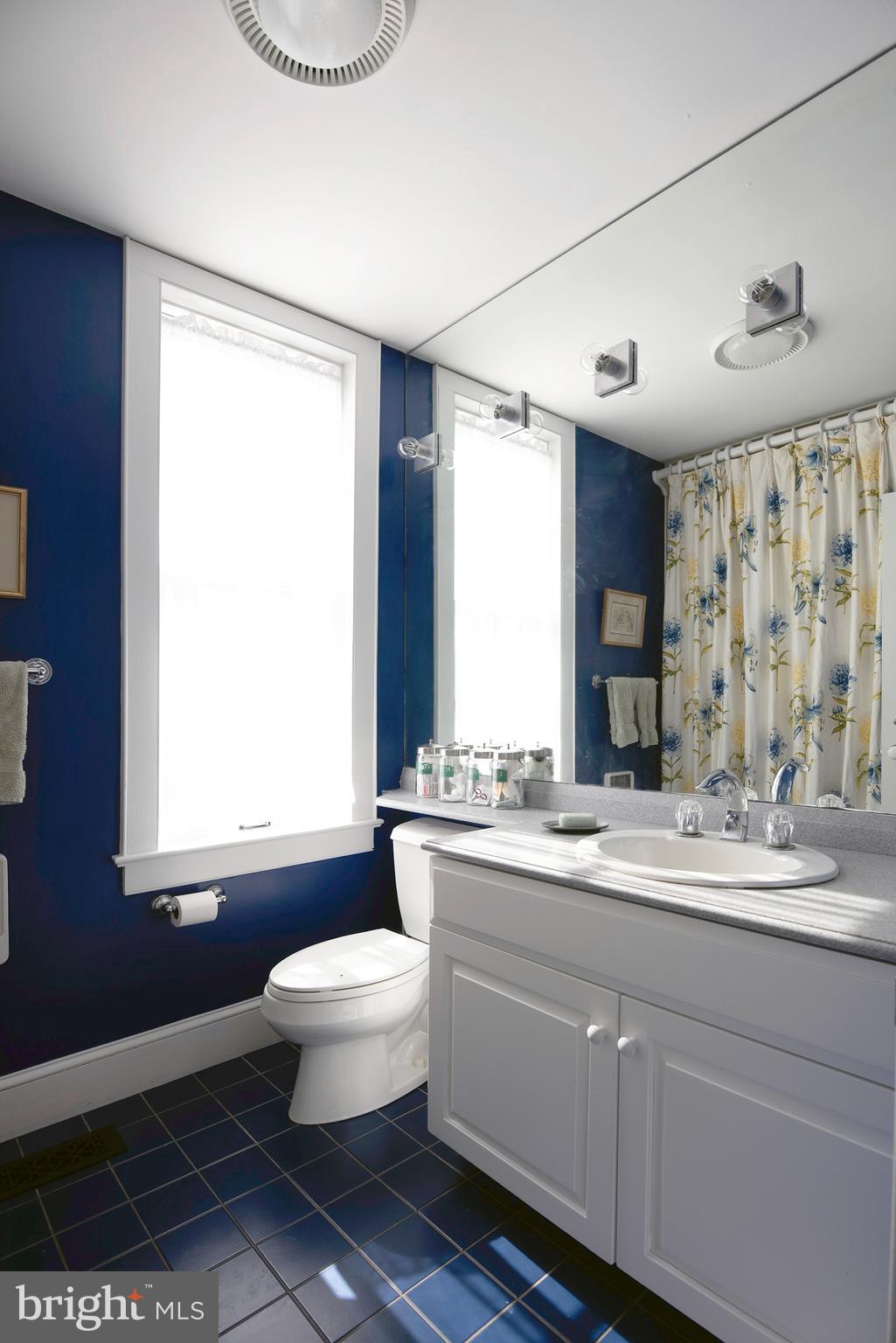 10121 Fairlee Road Chestertown, MD 21620 - Photo 26 of 66 a bathroom with a granite countertop sink toilet a large mirror and a window