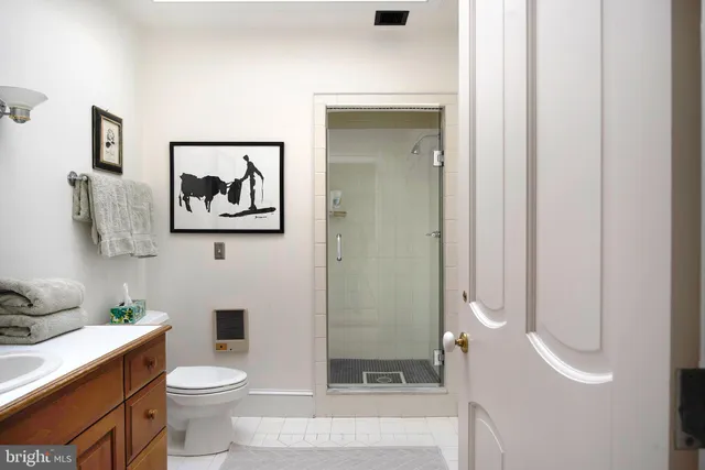 a bedroom with a bed mirror and window