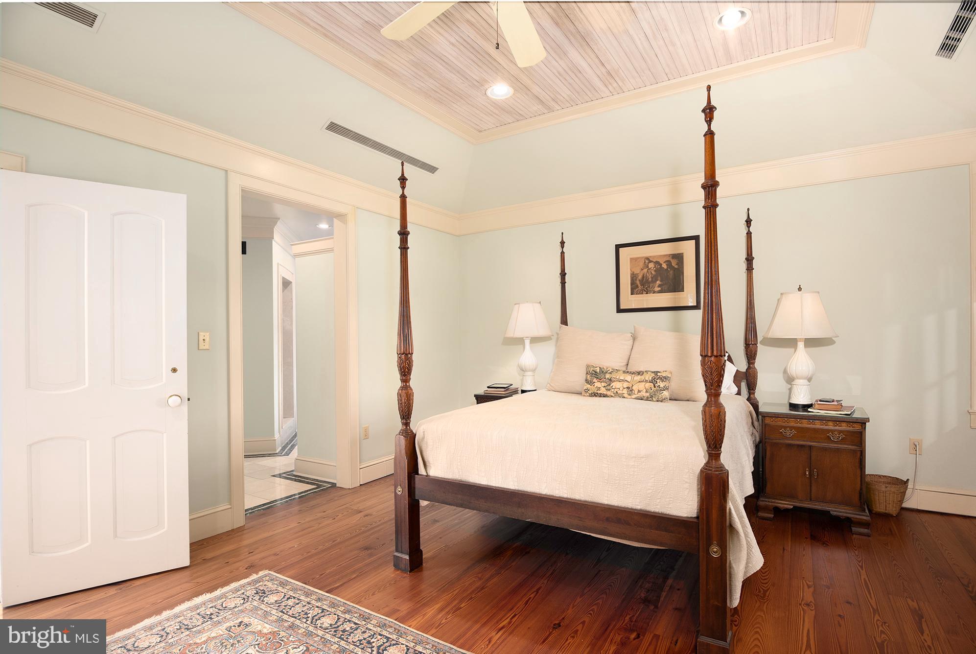 10121 Fairlee Road Chestertown, MD 21620 - Photo 36 of 66 a bedroom with a bed a lamp and wooden floor