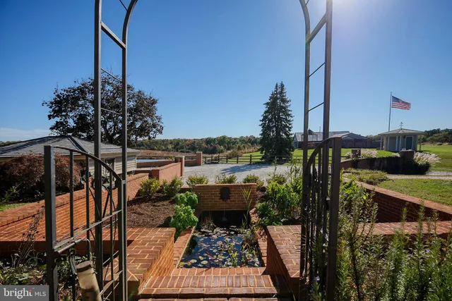 a view of a swimming pool and lounge chairs in the patio
