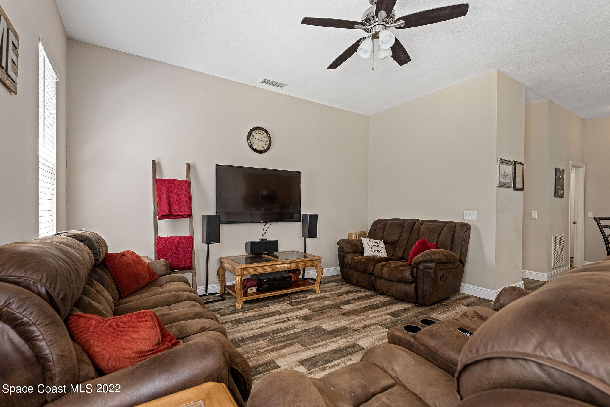 1744 Hydrangea Road Palm Bay, FL 32907 - Photo 17 of 34 a living room with furniture and a flat screen tv