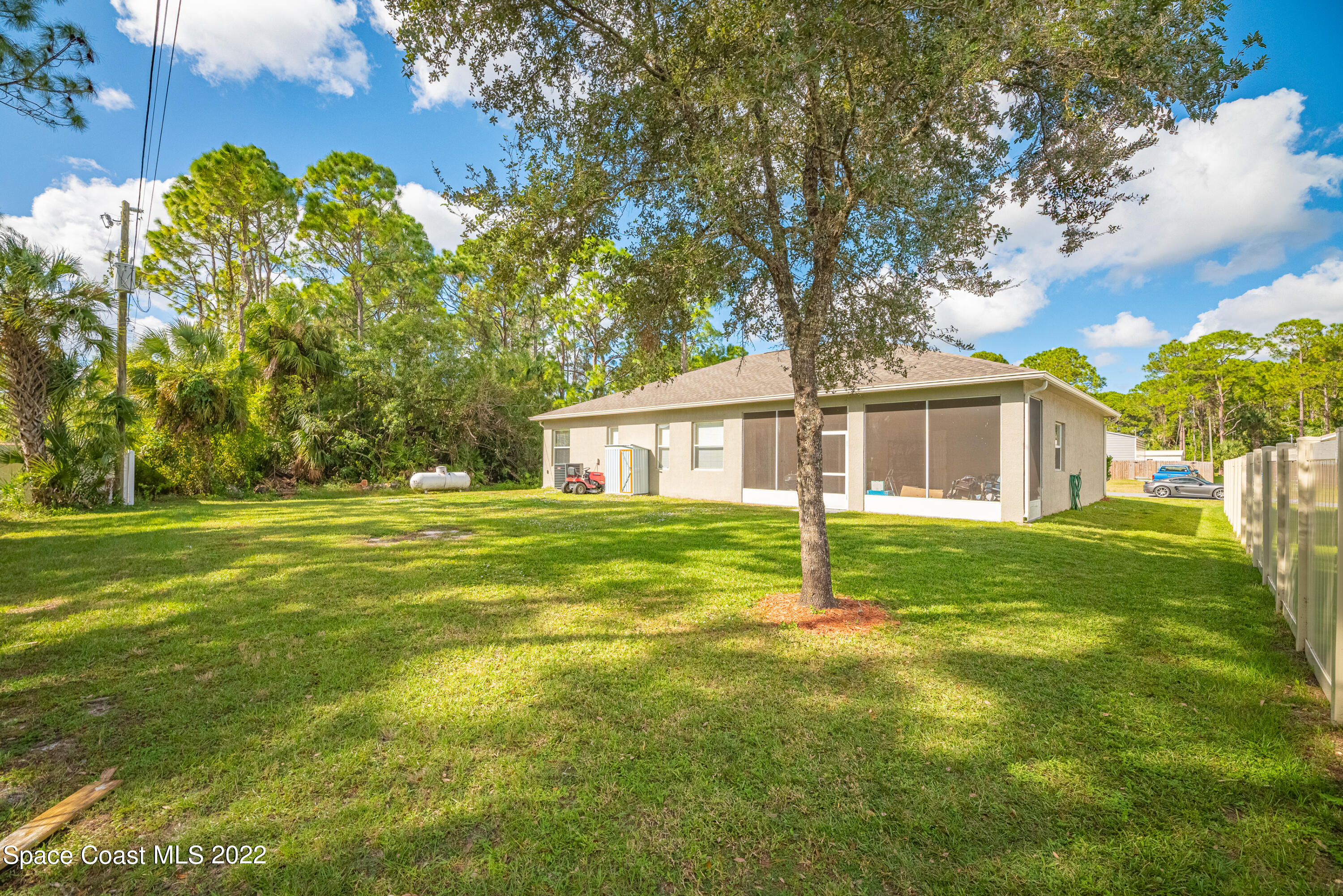 1744 Hydrangea Road Palm Bay, FL 32907 - Photo 4 of 34 a house that is sitting in the grass