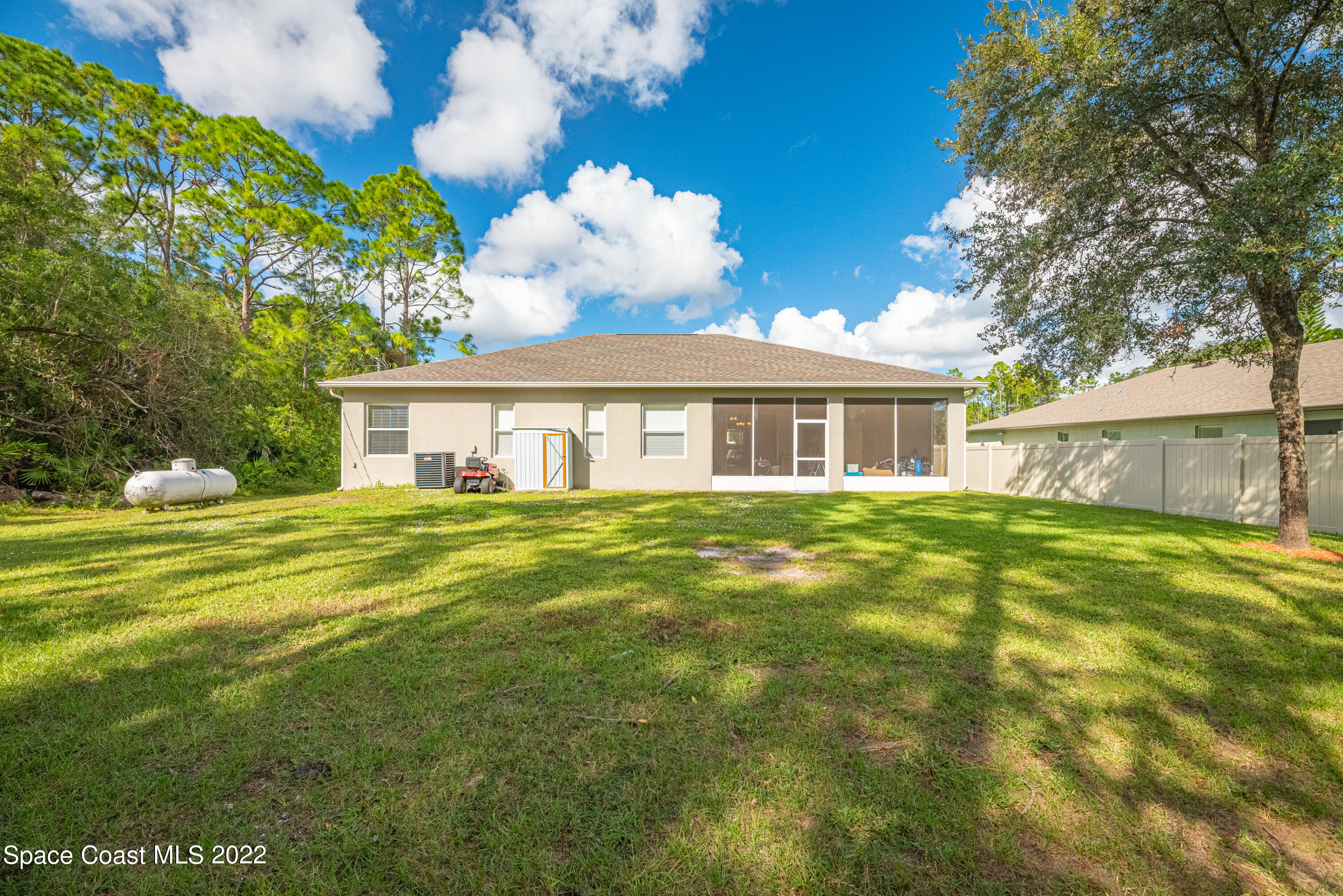 1744 Hydrangea Road Palm Bay, FL 32907 - Photo 5 of 34 a front view of a house with a garden