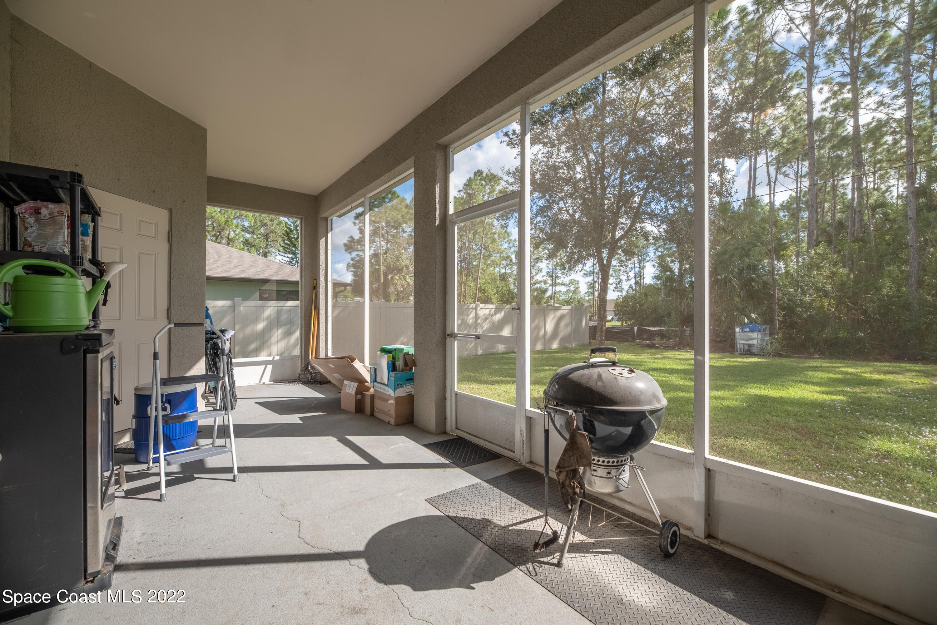 1744 Hydrangea Road Palm Bay, FL 32907 - Photo 9 of 34 a living room with patio floor and a floor to ceiling window
