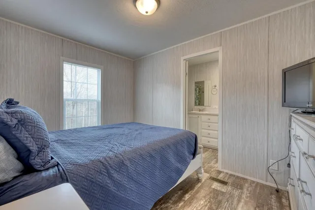 a bedroom with a bed closet and flat tv screen