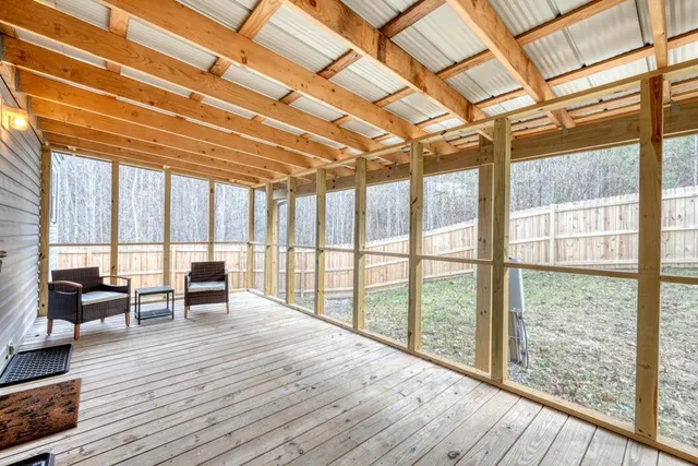 a view of room with wooden floor and furniture