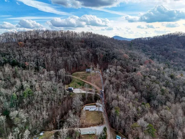 an aerial view of residential house and sandy dunes
