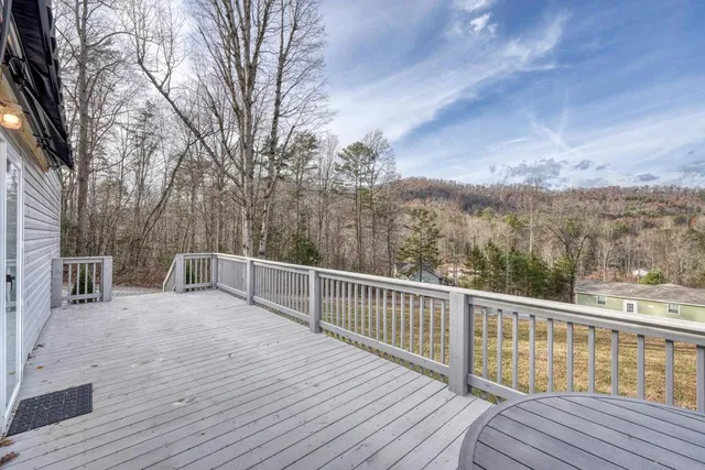 a view of balcony with wooden floor and fence