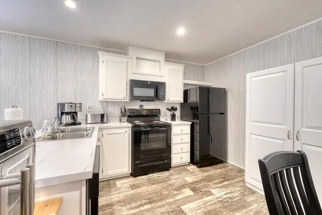 a kitchen with a refrigerator stove and sink