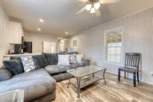 a living room with furniture and a chandelier