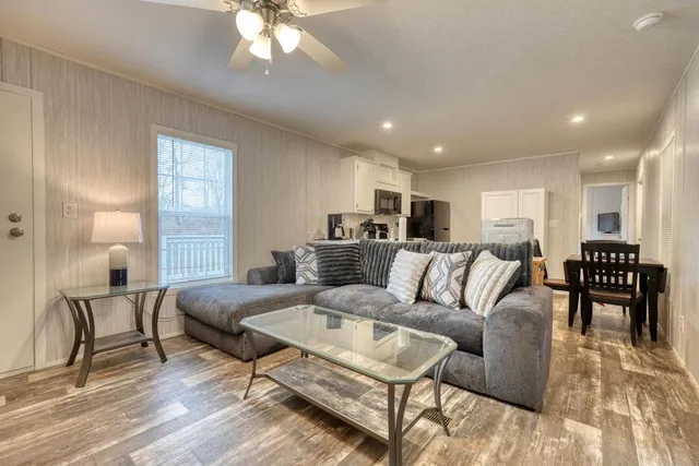 a living room with furniture and wooden floor
