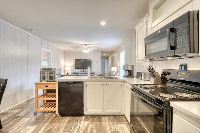 a kitchen with a stove top oven sink and cabinets