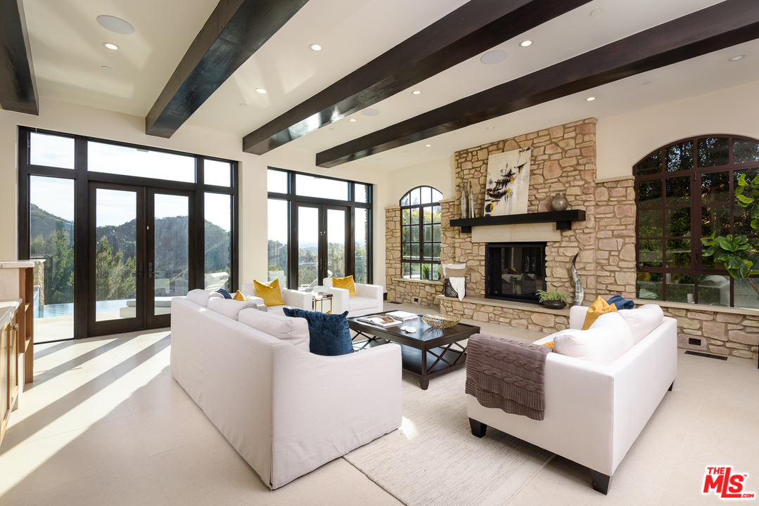 2175 Summitridge Drive Beverly Hills, CA 90210 - Photo 11 of 51 a living room with fireplace furniture and a fireplace