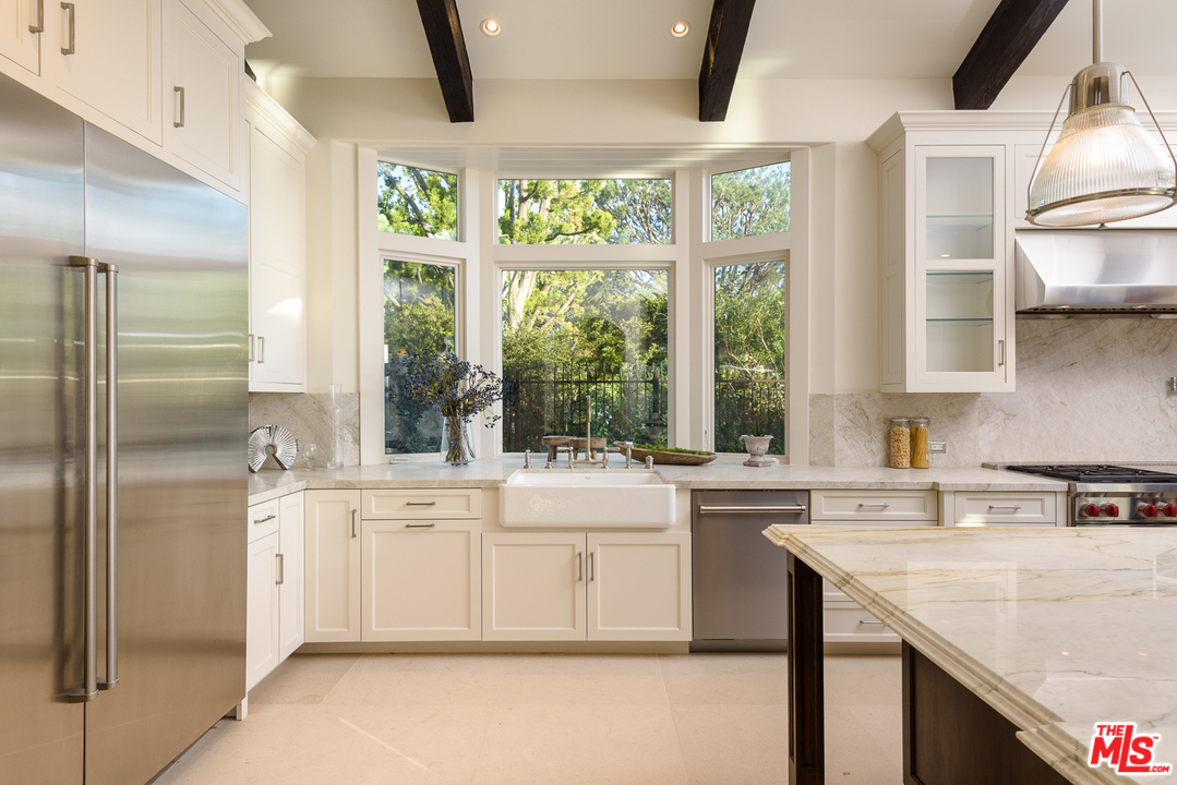 2175 Summitridge Drive Beverly Hills, CA 90210 - Photo 19 of 51 a kitchen with a stove a sink and a refrigerator