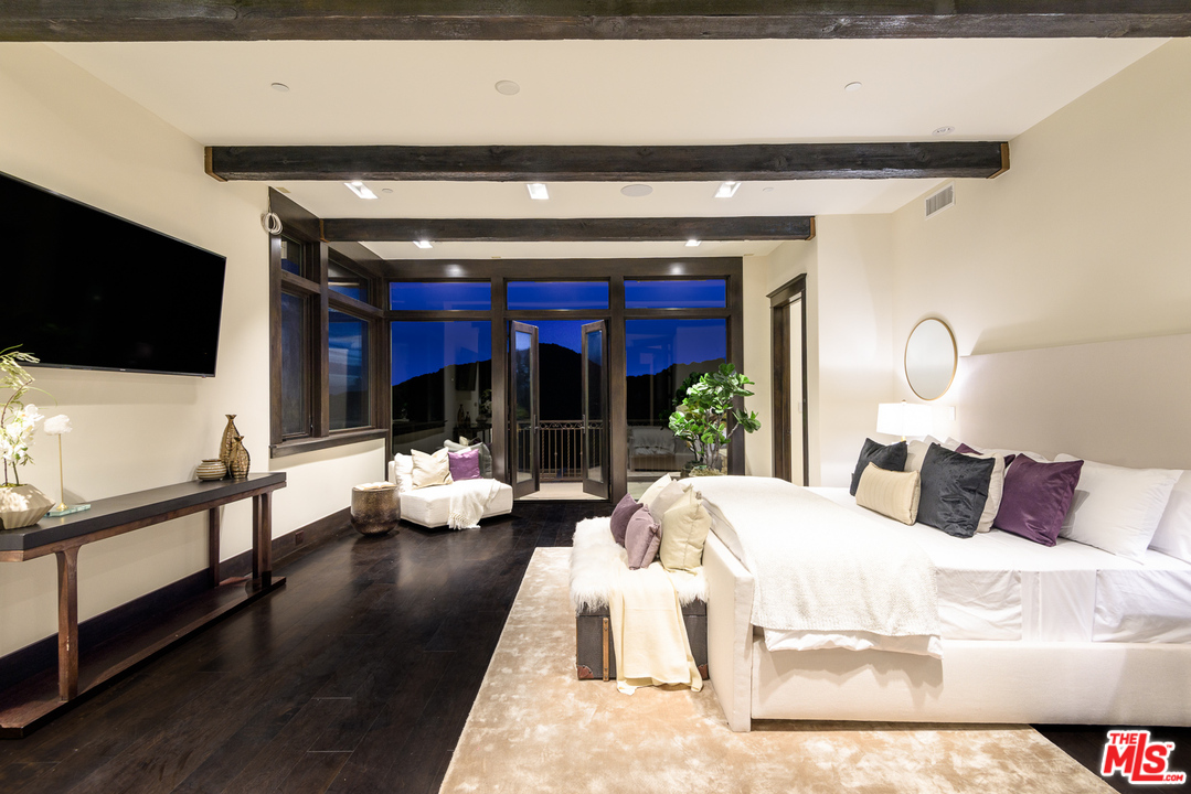 2175 Summitridge Drive Beverly Hills, CA 90210 - Photo 24 of 51 a living room with furniture and a flat screen tv