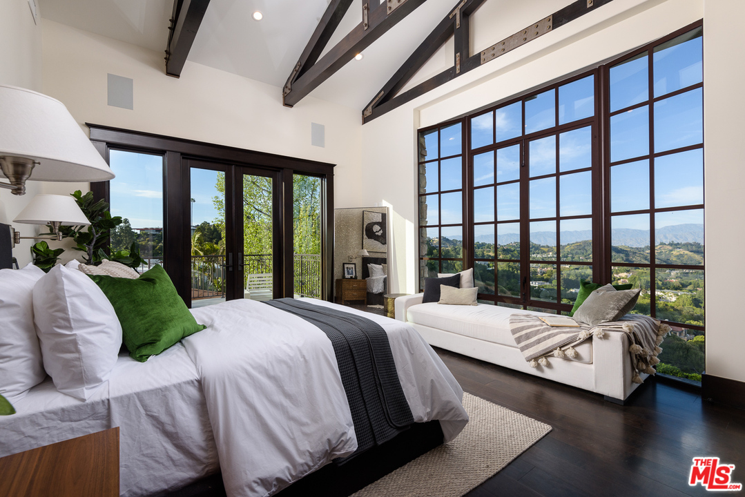 2175 Summitridge Drive Beverly Hills, CA 90210 - Photo 32 of 51 a bedroom with a bed and a large window