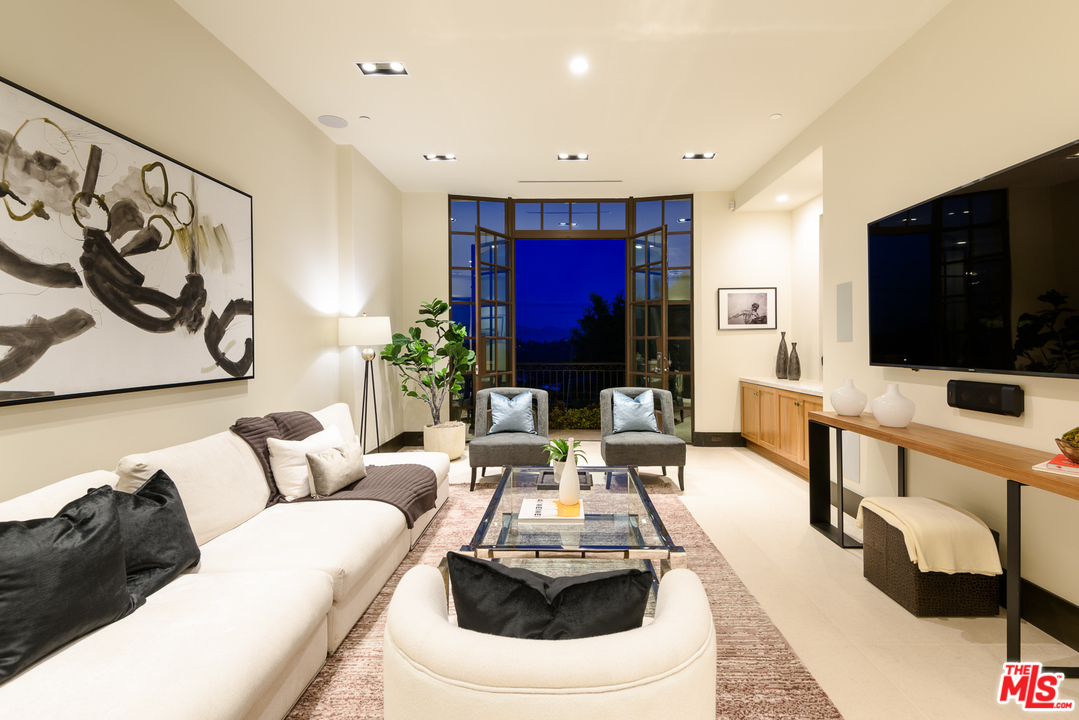 2175 Summitridge Drive Beverly Hills, CA 90210 - Photo 5 of 51 a living room with furniture and a flat screen tv