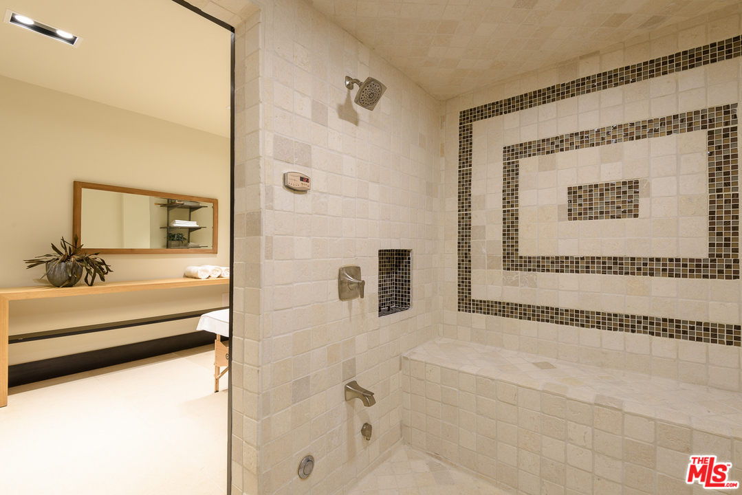 2175 Summitridge Drive Beverly Hills, CA 90210 - Photo 41 of 51 a bathroom with a bathtub and a shower