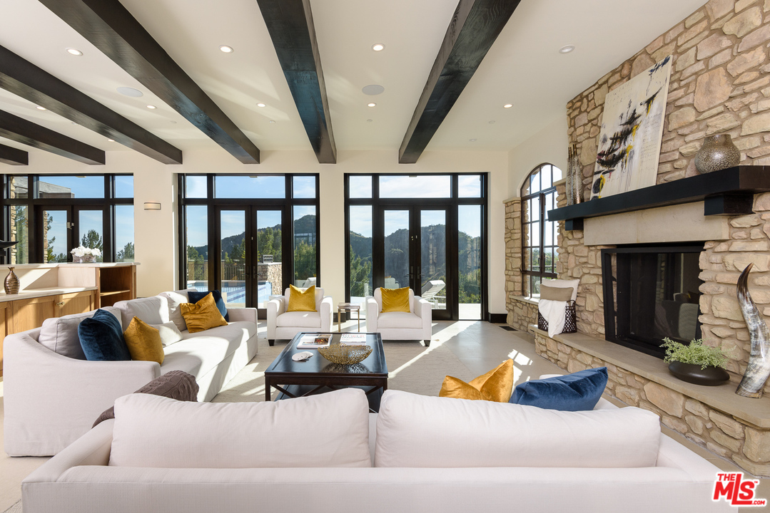 2175 Summitridge Drive Beverly Hills, CA 90210 - Photo 10 of 51 a living room with furniture fireplace and large windows