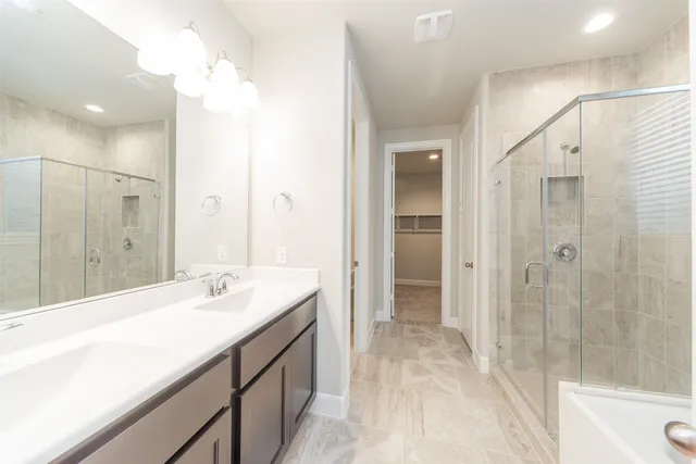 a spacious bathroom with a shower sink vanity and mirror