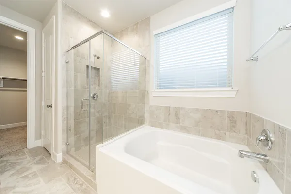 a bathroom with a bathtub and shower