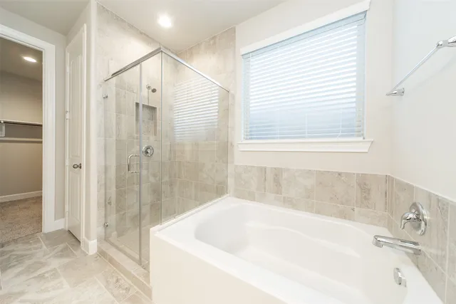 a bathroom with a bathtub and shower