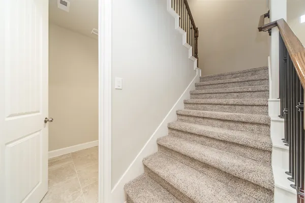 a view of staircase with white walls