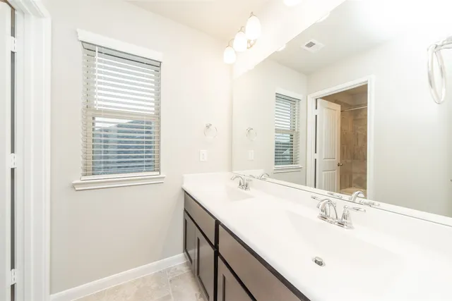 a bathroom with a sink vanity and a mirror